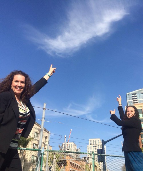 Image of Sharon and Dana in San Diego at CSUN pointing to clouds