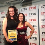 Dana and Sharon posing with her award on the stage