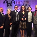 Dana with her family with award backdrop